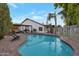 Backyard pool with a lounge area, surrounded by lush greenery, offering a private and serene outdoor retreat at 928 S San Joaquin Ct, Gilbert, AZ 85296