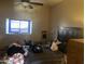 Bedroom featuring a window, ceiling fan, and a wooden headboard at 94 W 12Th St, Florence, AZ 85132