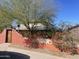 Charming house with a stucco wall, mature landscaping and a welcoming gate at 94 W 12Th St, Florence, AZ 85132