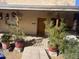 Inviting front porch with potted plants and wooden door at 94 W 12Th St, Florence, AZ 85132