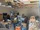 Messy garage features unfinished ceiling and storage at 94 W 12Th St, Florence, AZ 85132