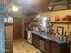 View of kitchen with wood cabinets, a blue tile countertop, tile flooring, and a wood ceiling at 94 W 12Th St, Florence, AZ 85132