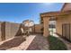 Enclosed backyard with patio, an outdoor dining set, brick walls and desert landscaping at 945 N Pasadena -- # 52, Mesa, AZ 85201