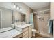 Stylish bathroom featuring a marble countertop, modern vanity, and tiled shower with a shower bench at 945 N Pasadena -- # 52, Mesa, AZ 85201