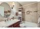 Bathroom featuring a large, round mirror, modern vanity, and tiled shower with bathtub at 945 N Pasadena -- # 52, Mesa, AZ 85201