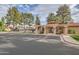 Community entrance with desert landscaping and ample parking at 945 N Pasadena -- # 52, Mesa, AZ 85201