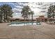 Enjoy the community pool with a covered patio, lounge chairs and palm trees at 945 N Pasadena -- # 52, Mesa, AZ 85201