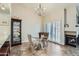 Bright dining room with a glass table set, display cabinet, fireplace, and large shuttered windows at 945 N Pasadena -- # 52, Mesa, AZ 85201