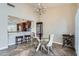 Cozy dining area featuring a glass table, chandelier, and seamless flow to the adjacent kitchen at 945 N Pasadena -- # 52, Mesa, AZ 85201