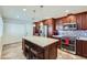 Modern kitchen with a central island, stainless steel appliances, and dark wood cabinetry at 945 N Pasadena -- # 52, Mesa, AZ 85201