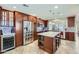 Spacious kitchen featuring stainless steel appliances, dark wood cabinets, and a large granite island at 945 N Pasadena -- # 52, Mesa, AZ 85201