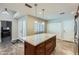 Kitchen island with granite countertops and seating, complemented by natural light and storage space at 945 N Pasadena -- # 52, Mesa, AZ 85201