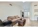 Bright living room with a skylight, cozy seating, and tiled flooring for a modern feel at 945 N Pasadena -- # 52, Mesa, AZ 85201