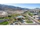 Aerial view of community clubhouse with pool, bordered by desert landscaping and mountain backdrop at 9814 S 11Th St, Phoenix, AZ 85042