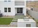 Manicured backyard featuring modern turf, a built-in grill, and access to the home at 9814 S 11Th St, Phoenix, AZ 85042