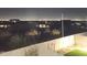 Serene backyard view showcasing a well-maintained wall and distant city lights at night at 9814 S 11Th St, Phoenix, AZ 85042