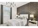 Comfortable bedroom featuring a neutral color palette, modern chandelier and decorative accent wall at 9814 S 11Th St, Phoenix, AZ 85042