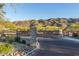 Gated community entrance with decorative metal gate and attractive desert landscaping against a mountain backdrop at 9814 S 11Th St, Phoenix, AZ 85042