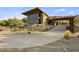 Exterior view of modern building with large windows, desert landscaping, and mountain views at 9814 S 11Th St, Phoenix, AZ 85042