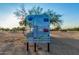 Park information sign including park rules, address, and contact information in a landscaped area at 9814 S 11Th St, Phoenix, AZ 85042