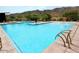 Large community pool with clear blue water and a beautiful mountain backdrop at 9814 S 11Th St, Phoenix, AZ 85042