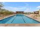 Community lap pool with lounge area, desert landscaping, and mountain views at 9814 S 11Th St, Phoenix, AZ 85042