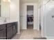 Bathroom featuring a walk-in shower, a vanity with a sink, and access to a closet space at 1021 W Descanso Canyon Dr, Casa Grande, AZ 85122