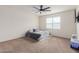 A carpeted bedroom featuring a ceiling fan and a window providing natural light at 1021 W Descanso Canyon Dr, Casa Grande, AZ 85122