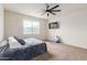 Cozy bedroom featuring a ceiling fan, large windows, and neutral carpeting at 1021 W Descanso Canyon Dr, Casa Grande, AZ 85122