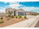 Beautiful single story home featuring low maintenance landscaping, a long driveway, and a three car garage at 1021 W Descanso Canyon Dr, Casa Grande, AZ 85122