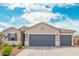 Inviting home exterior featuring a three-car garage, desert landscaping, and a well-maintained facade at 1021 W Descanso Canyon Dr, Casa Grande, AZ 85122