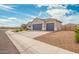 Charming single-story home showcasing a spacious three-car garage and low-maintenance desert landscaping at 1021 W Descanso Canyon Dr, Casa Grande, AZ 85122