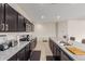 Kitchen area with granite countertops, stainless steel appliances, dark cabinets, and an island with seating at 1021 W Descanso Canyon Dr, Casa Grande, AZ 85122