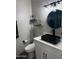 Modern bathroom featuring black sink, round mirror, and floating shelves at 1030 E Susan Ln, Tempe, AZ 85288