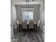 Dining room with gray plank flooring, modern light fixture, and plantation shutters at 1030 E Susan Ln, Tempe, AZ 85288