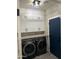 Efficient laundry room with front loading washer/dryer and ample cabinet space at 1030 E Susan Ln, Tempe, AZ 85288