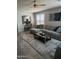 Inviting living room with gray plank flooring, breakfast bar, and large windows at 1030 E Susan Ln, Tempe, AZ 85288