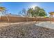 The private backyard features a rock landscape, brick wall, and mature shade trees at 10307 W Windsor Blvd, Glendale, AZ 85307