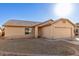 Lovely single-story home with a two-car garage, neutral color palette, and low-maintenance desert landscaping at 10307 W Windsor Blvd, Glendale, AZ 85307