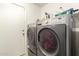 The laundry room features a full-sized washer and dryer with shelving at 10307 W Windsor Blvd, Glendale, AZ 85307