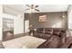 Comfortable living room featuring wood-look floors, soft lighting, and seamless access to other living spaces at 10307 W Windsor Blvd, Glendale, AZ 85307