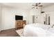 Spacious main bedroom features wood floors, a ceiling fan, and an ensuite bathroom at 10307 W Windsor Blvd, Glendale, AZ 85307