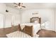 This bright main bedroom has wood floors, a ceiling fan, and natural light at 10307 W Windsor Blvd, Glendale, AZ 85307