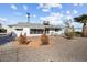 Expansive backyard featuring desert landscaping, a covered patio, and a well-maintained gravel area at 10423 W Monterosa Dr, Sun City, AZ 85351