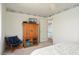 Bedroom with a chair, dark-wood cabinet, and doorway to another room at 10423 W Monterosa Dr, Sun City, AZ 85351