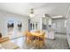 Bright dining area with a wooden table, comfortable seating, and seamless connection to the well-equipped kitchen at 10423 W Monterosa Dr, Sun City, AZ 85351