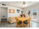 Inviting dining space with a wooden table, comfortable seating, and access to the outdoors through French doors at 10423 W Monterosa Dr, Sun City, AZ 85351