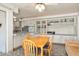 Open kitchen and dining area features built in cabinets, a ceiling fan, and a four seat table at 10423 W Monterosa Dr, Sun City, AZ 85351