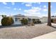 Single story home featuring desert landscaping with bushes and a mature palm tree in the front yard at 10423 W Monterosa Dr, Sun City, AZ 85351