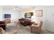 Cozy living room featuring neutral walls, carpet flooring, ceiling fan, and a window with natural light at 10423 W Monterosa Dr, Sun City, AZ 85351